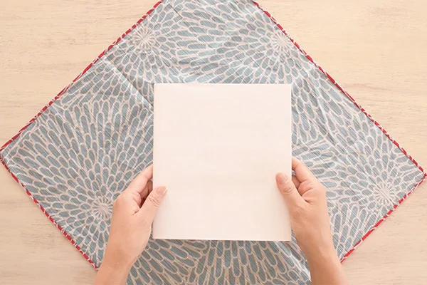 Step 1: Place your Furoshiki (square fabric) upside down in diagonal position.
