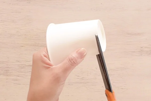 Step 1: Cut the bottom and top of the paper cup to make a template.