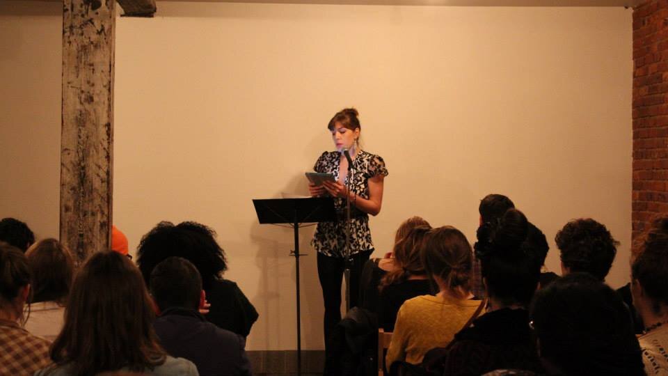 Sarah reading at an Apogee Journal event.