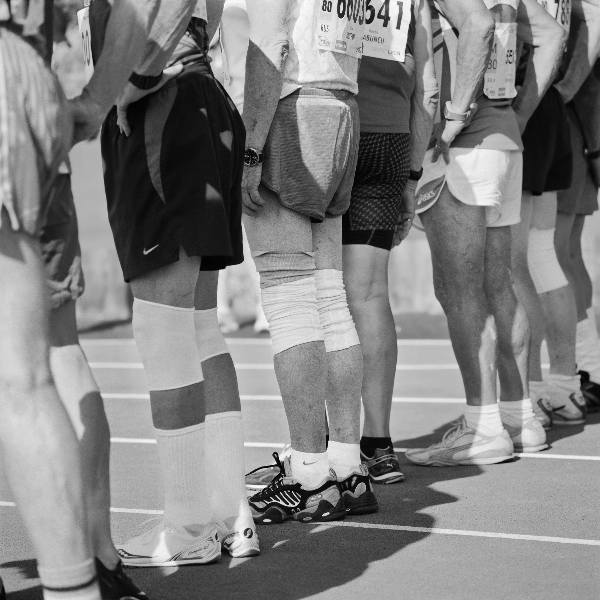 Men's 80-84 and 85-89 decathletes, on the 1500-meter run starting line. World Masters. Lyon, France. 2015.