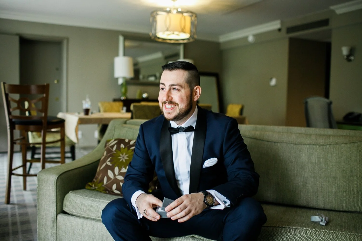 14_Groom opening gift at Whitby Castle wedding in Rye NY.jpg