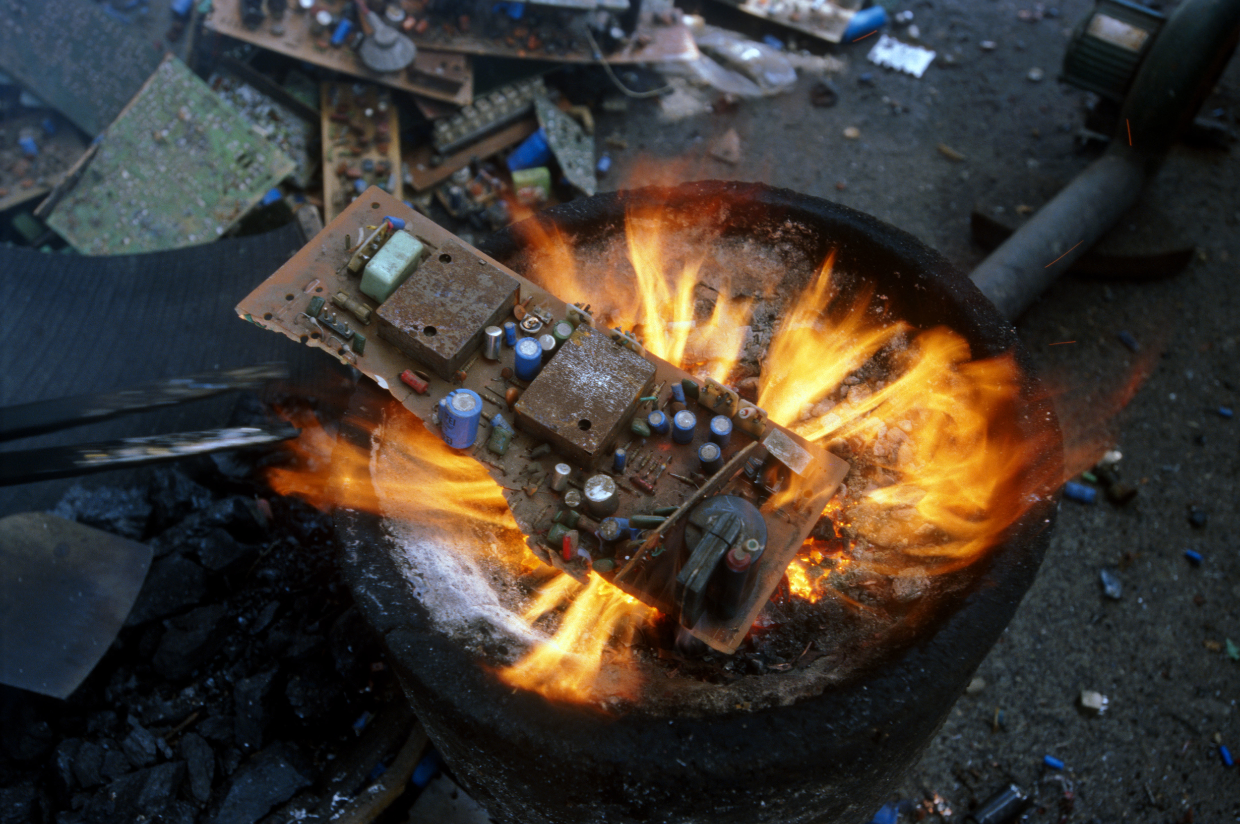 Burning a circuit board over an open fire release dioxins and furans