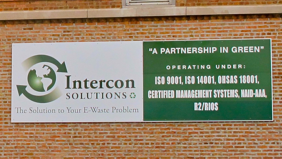 Close-up of Intercon Solutions' sign touting their Certifications. 2014. Copyright BAN.