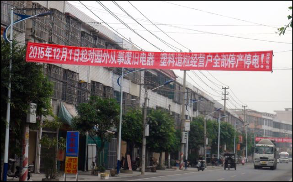 Banner proclaiming deadline of December 1, 2015 for all recyclers to move to Industrial Park or face power cut-off. Copyright BAN 2015.