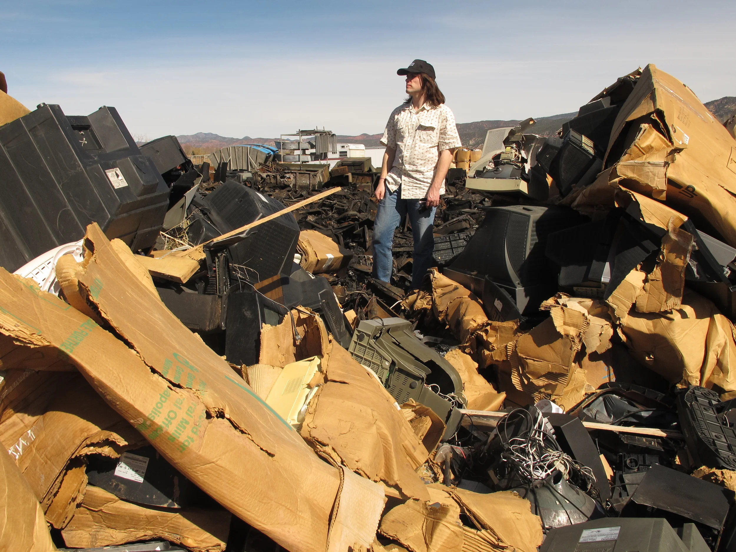 BAN's researcher scans the TV wasteland at Stone Castle Recycling, Parowan, Utah. Copyright BAN 2014.