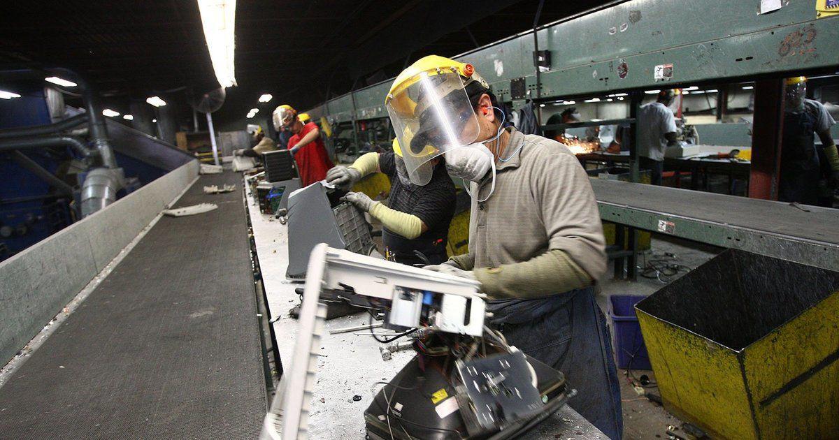 A worker dismantles a computer monitor at Total Reclaim in 2009. Total Reclaim co-founders Craig Lorch and Jeff Zirkle were each sentenced to two years and four months in prison by a federal judge in Seattle on Tuesday. (John Lok / The Seattle Times)