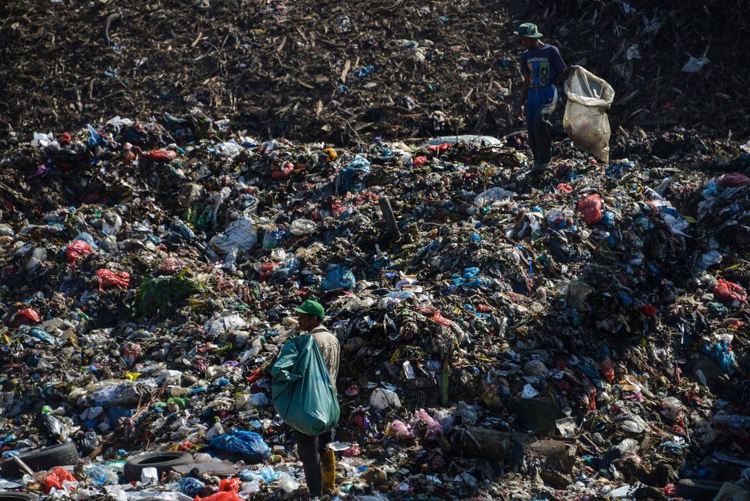 People collect plastic materials at a garbage dump in Banda Aceh, Indonesia, on March 23. The Basel Convention requires its signatories to seek permission from other countries before exporting hazardous and household waste. (CHAIDEER MAHYUDDIN / AFP/GETTY IMAGES)