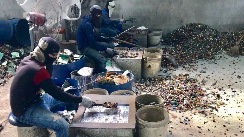 Workers smelt copper from electronic circuitry in a remote factory east of Bangkok, Thailand.