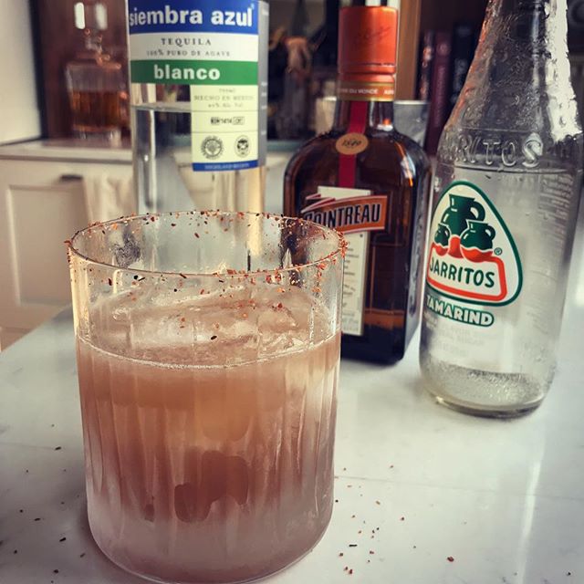 I had half of a tamarind @jarritos in the fridge and boiled it down to a half once of syrup. Then added lime and my favorite @siembraspirits and some @cointreau and a splash of cinnamon syrup too, and rimmed the glass with Taijin seasoning. Quite the tasty, spicy margarita! #cocktails #margarita #tequila #siembraazul #jarritos #tamarind #taijin