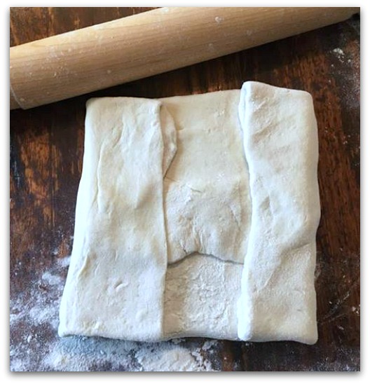 Dough folded over butter pack. No butter is visible.