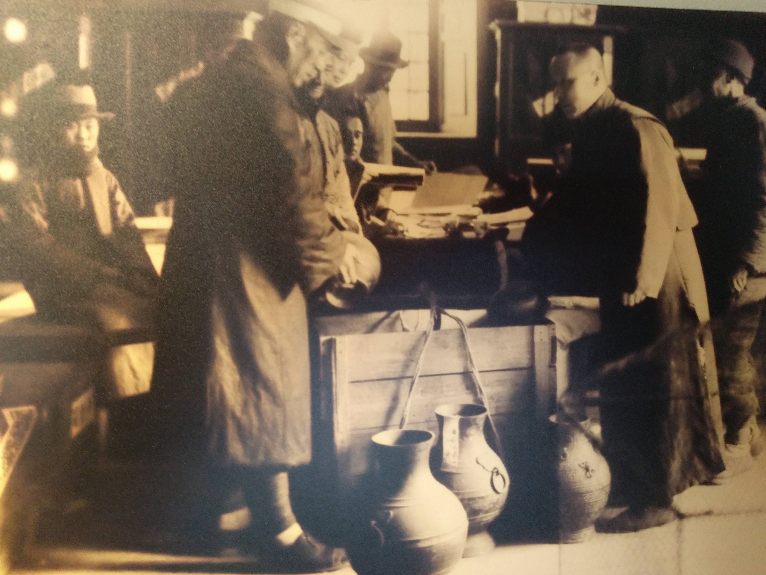  Palace Museum staff pack objects in wooden cases prior to evacuation from the Forbidden City, 1932.					  					  					  					  					 