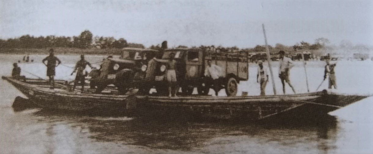  Trucks loaded with the imperial collections cross a river on a ferry.					  					  					  					  					 