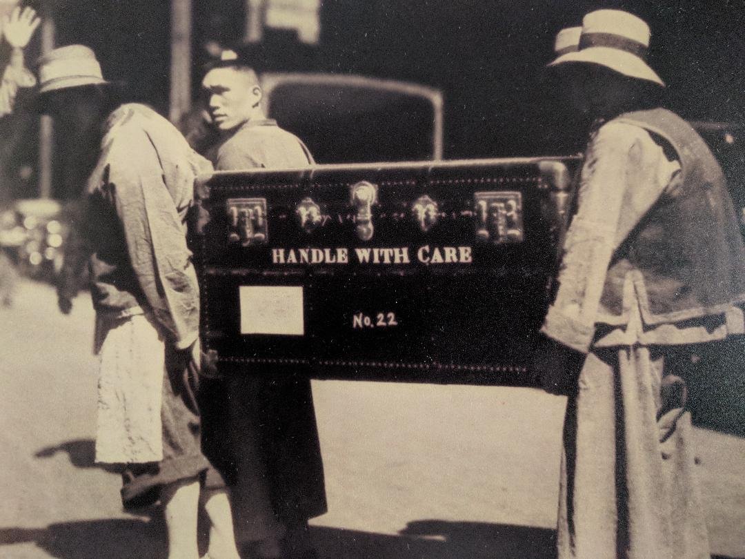  Porters load a case for the voyage to London, 1935					  					  					  					  					 