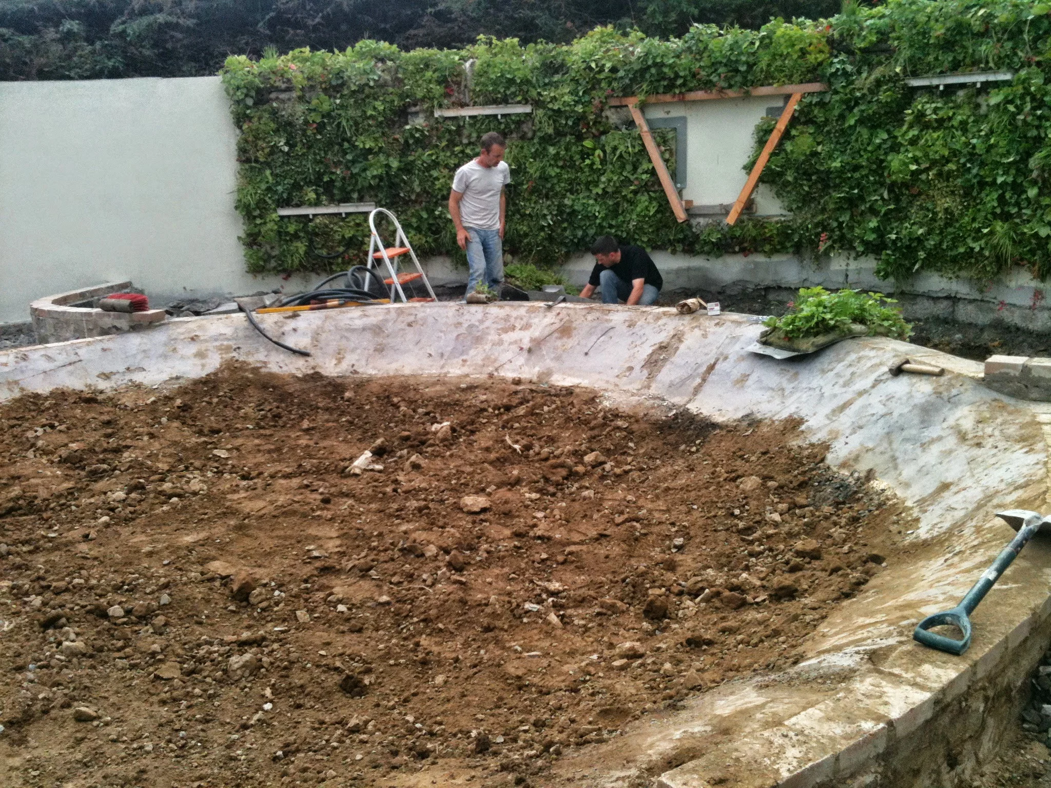 installing pond and vertical planting system.JPG
