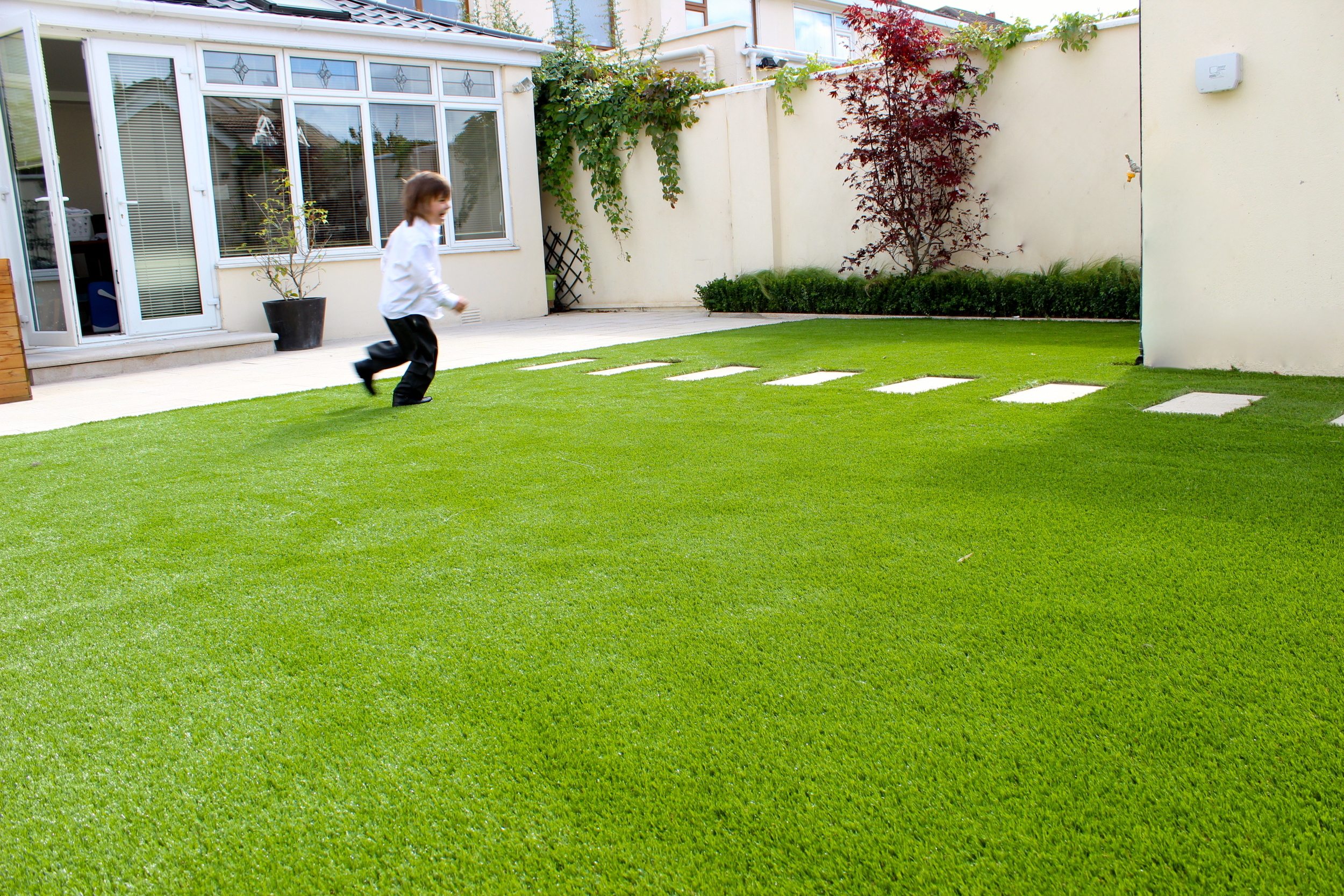 kid running on TigerTurf