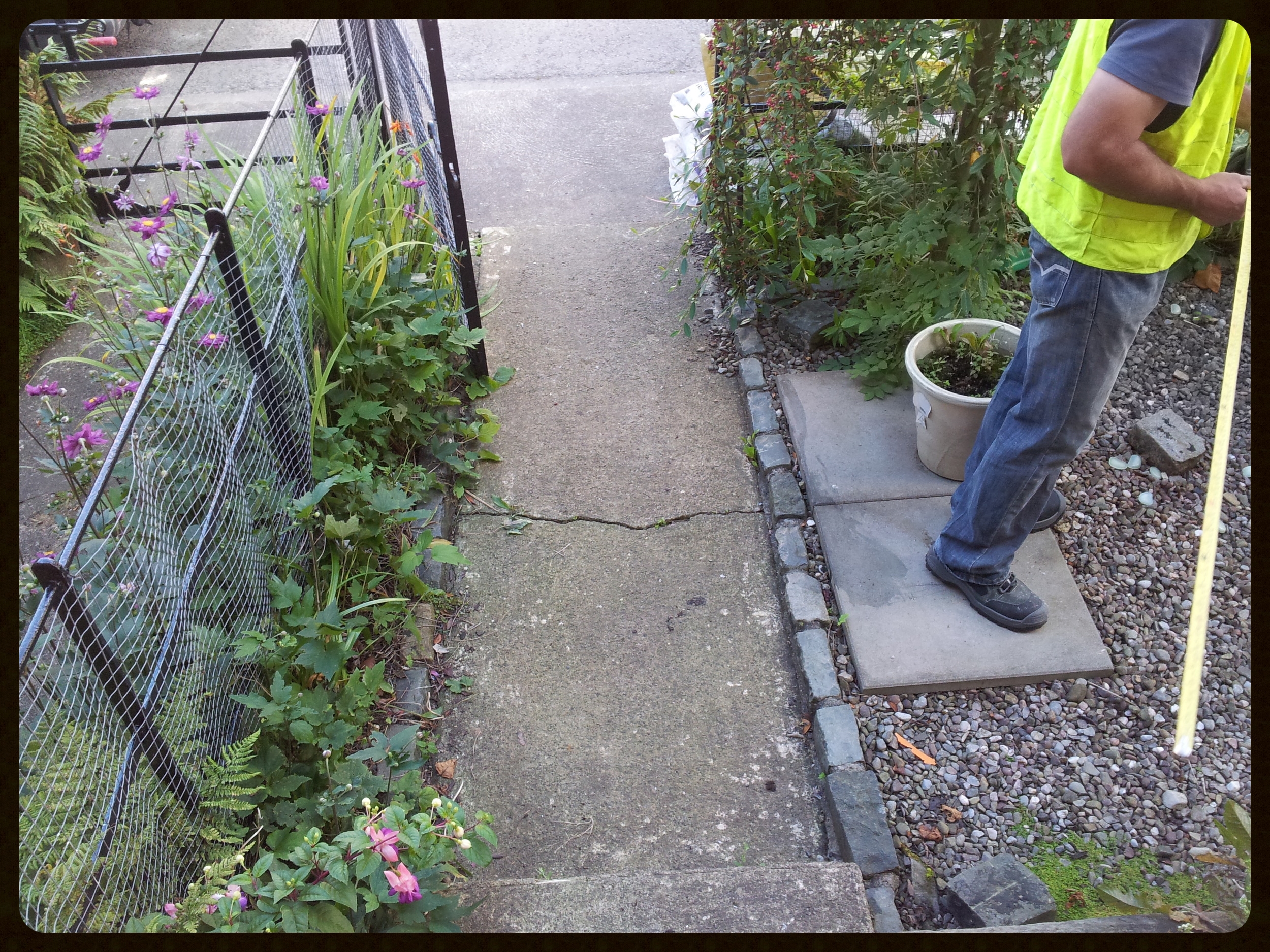 Landscaper measuring garden