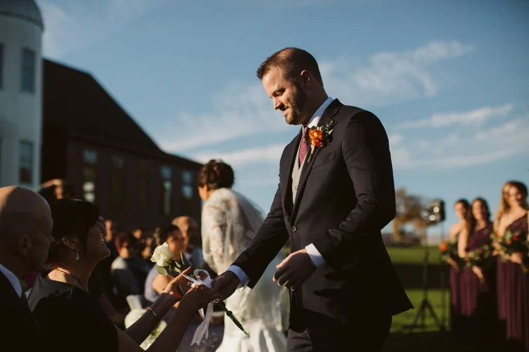 The couple framed by the rolling hills behind The Barn at Gibbet Hill