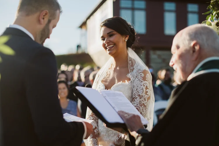 The couple standing in the open field at The Barn at Gibbet Hill