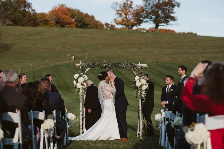 The couple together with the rolling Groton hills behind them