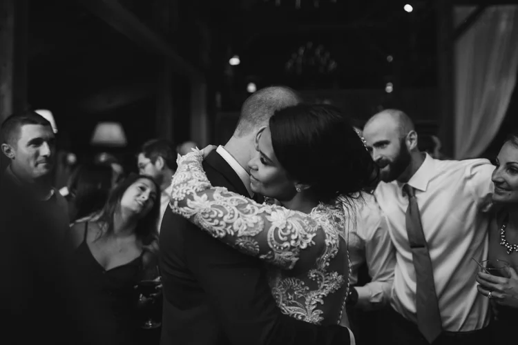 Amanda and Kevin celebrating with guests inside The Barn at Gibbet Hill