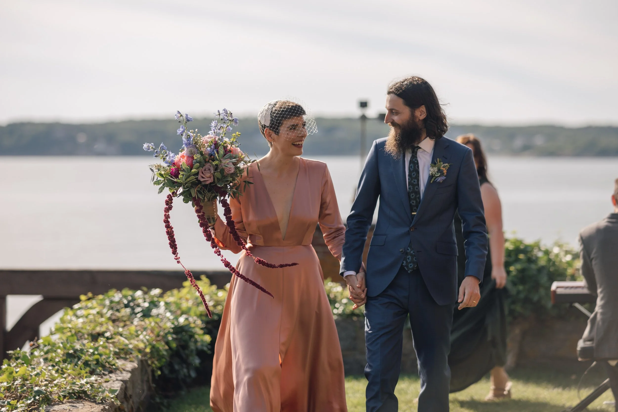 Wedding photographer in Boston captures couple laughing with ocean view at Beauport, the Sleeper-McCann House.