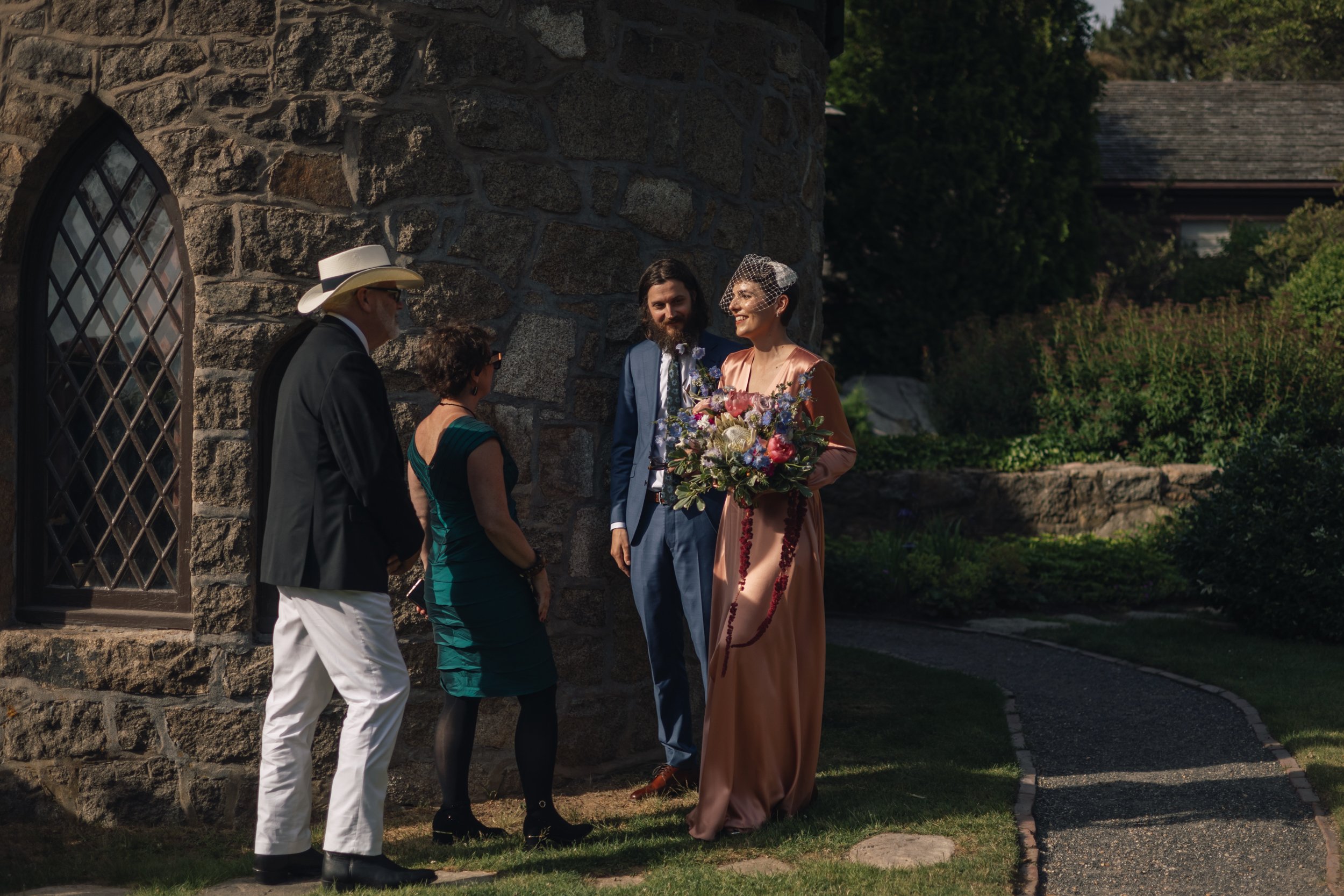 Boston documentary wedding photographer captures bride laughing during cocktail hour at Beauport, the Sleeper-McCann House.