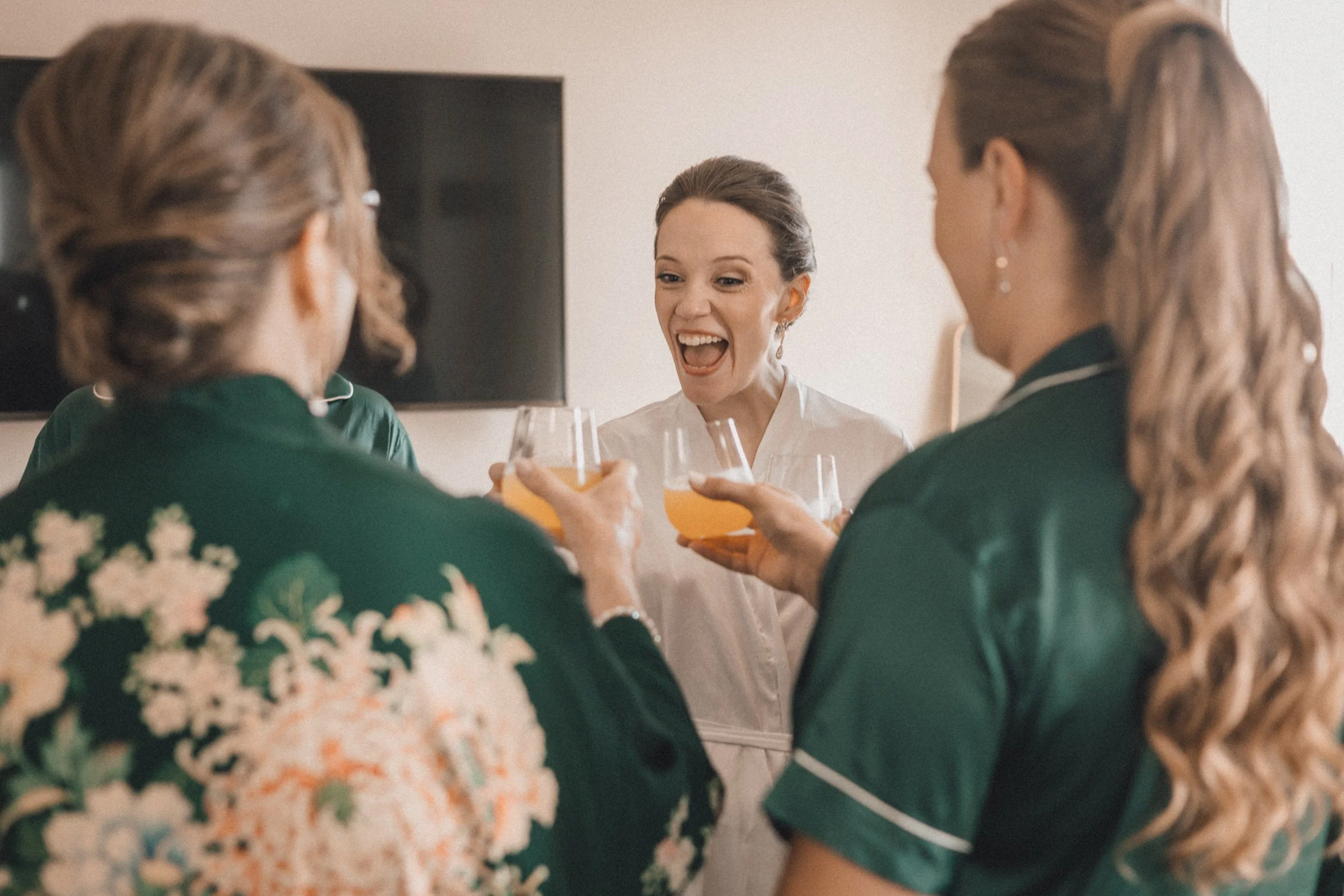 Bride and bridesmaids toasting before Peabody Essex Museum wedding reception.