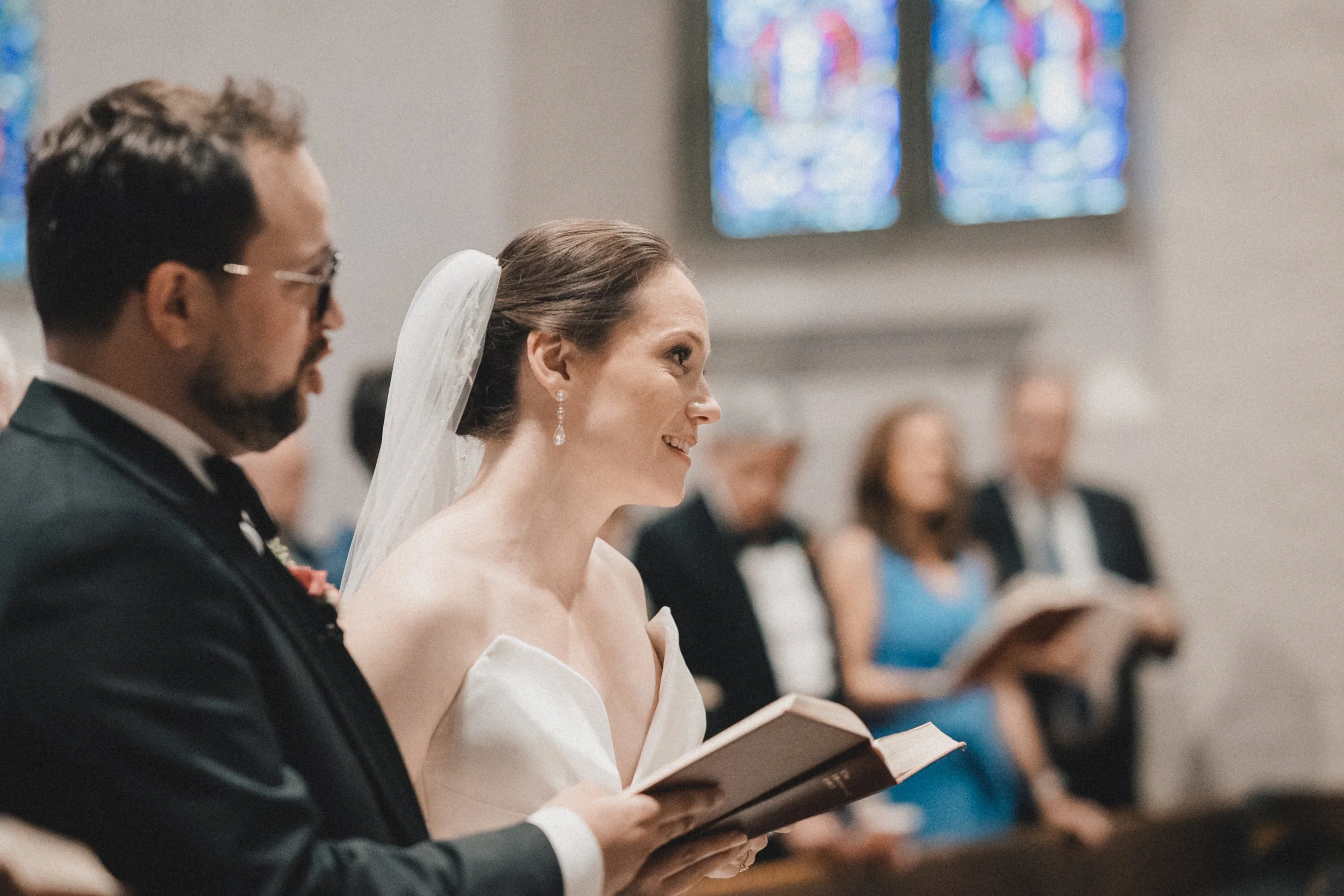 Bride and groom signing documents at Peabody Essex Museum wedding.