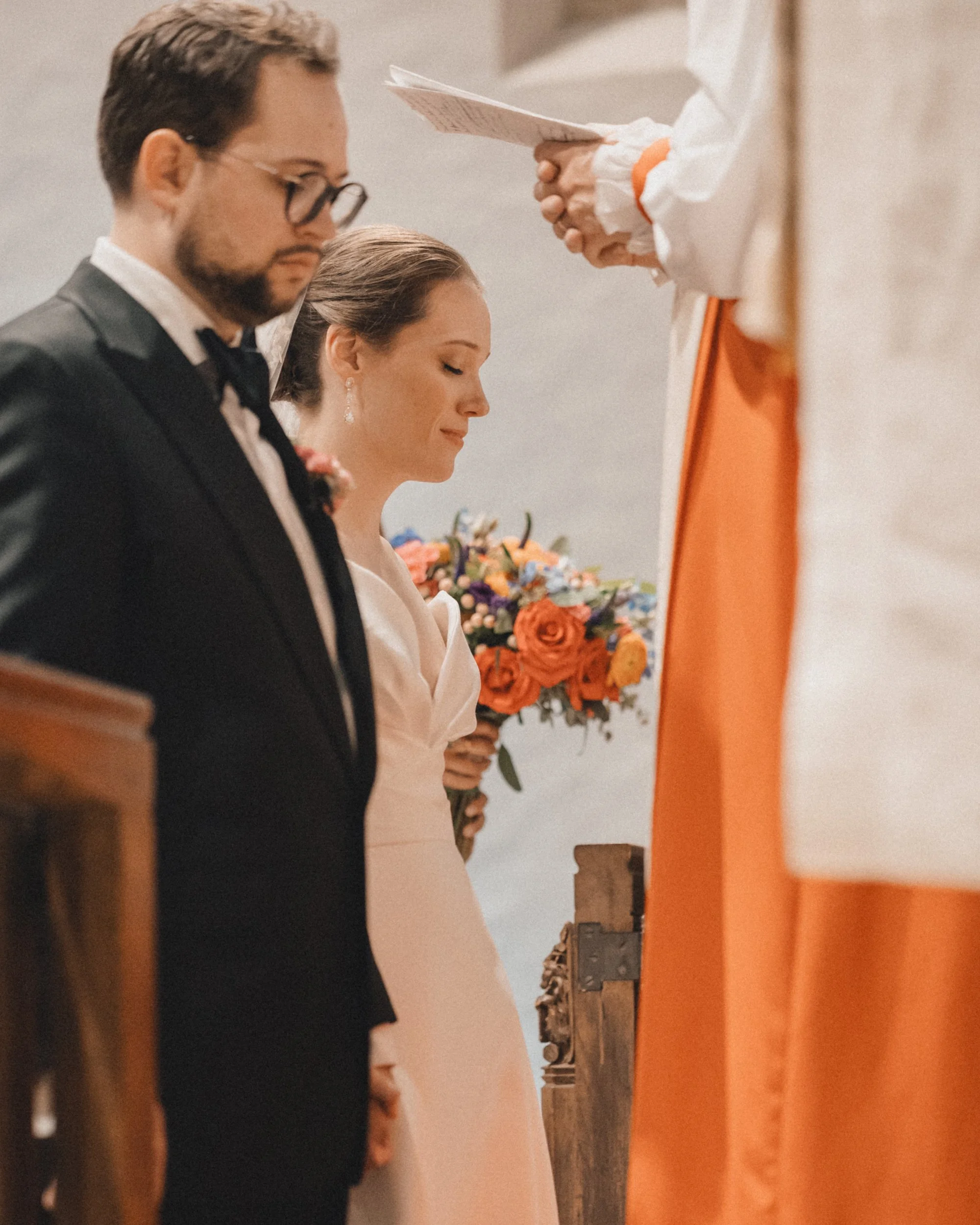 Bride and groom praying at Peabody Essex Museum wedding ceremony.