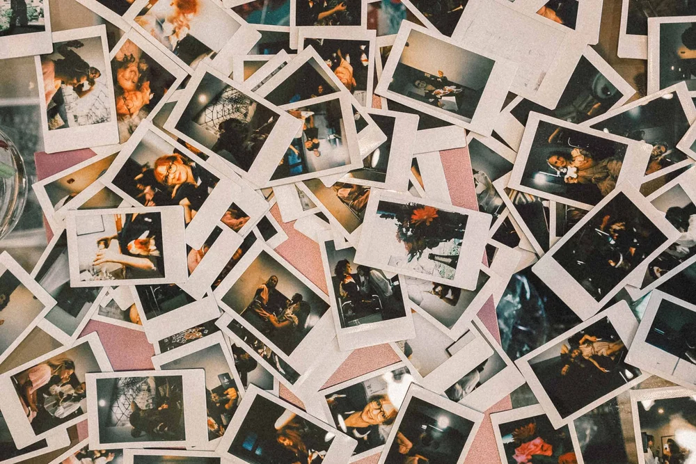 A collage of instant guest prints laid out together after a wedding reception