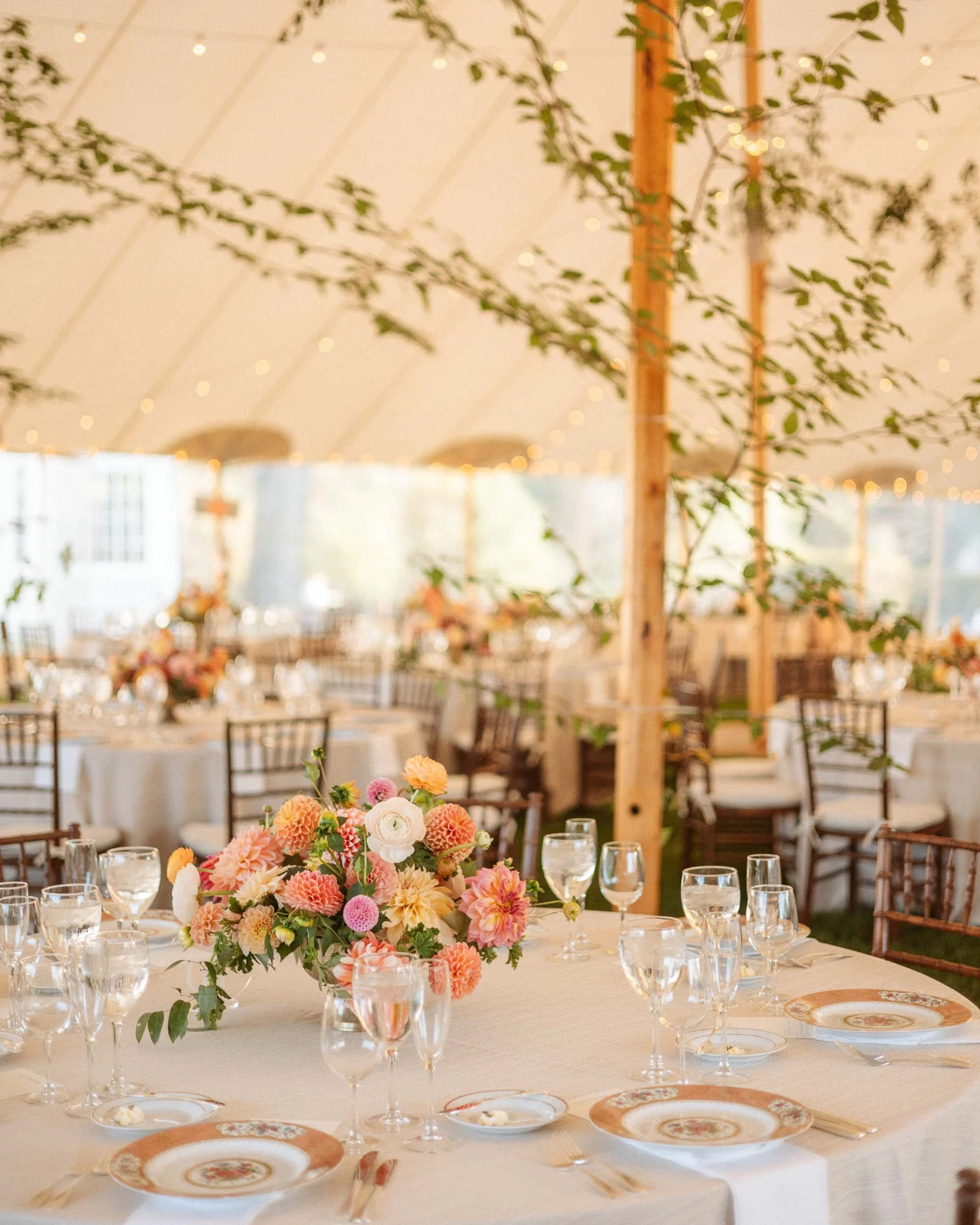 floral arrangement on a table in a wedding reception tent in sarasota Florida.