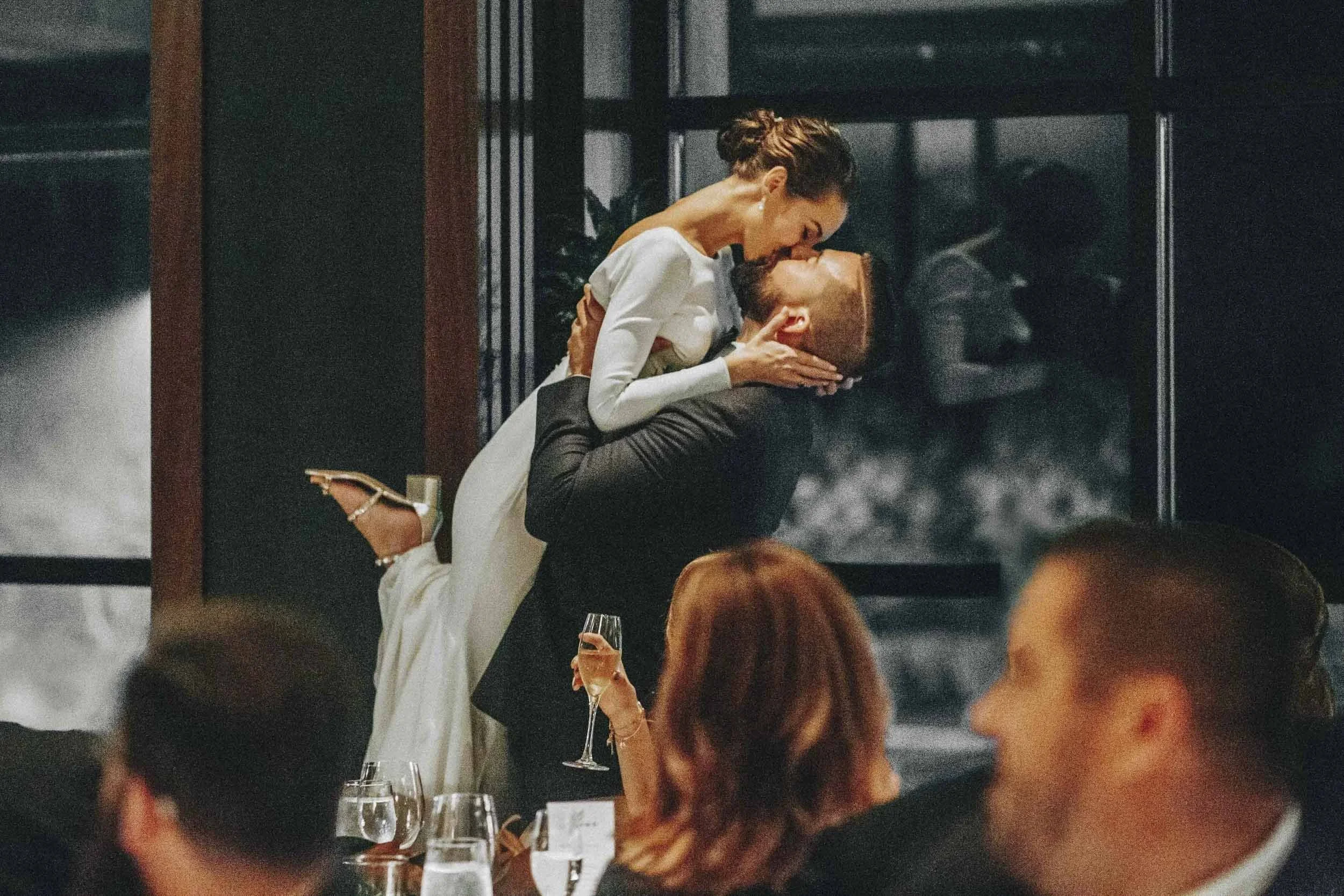 Couple kissing at Sarasota wedding reception — documentary wedding photography