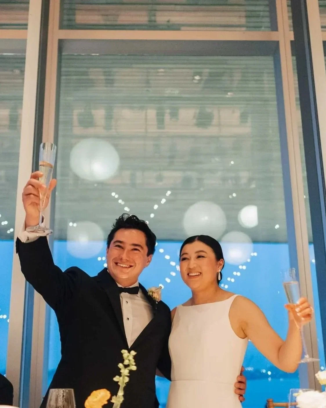 the bride and groom raising their glasses during a toast at their sarasota wedding reception.