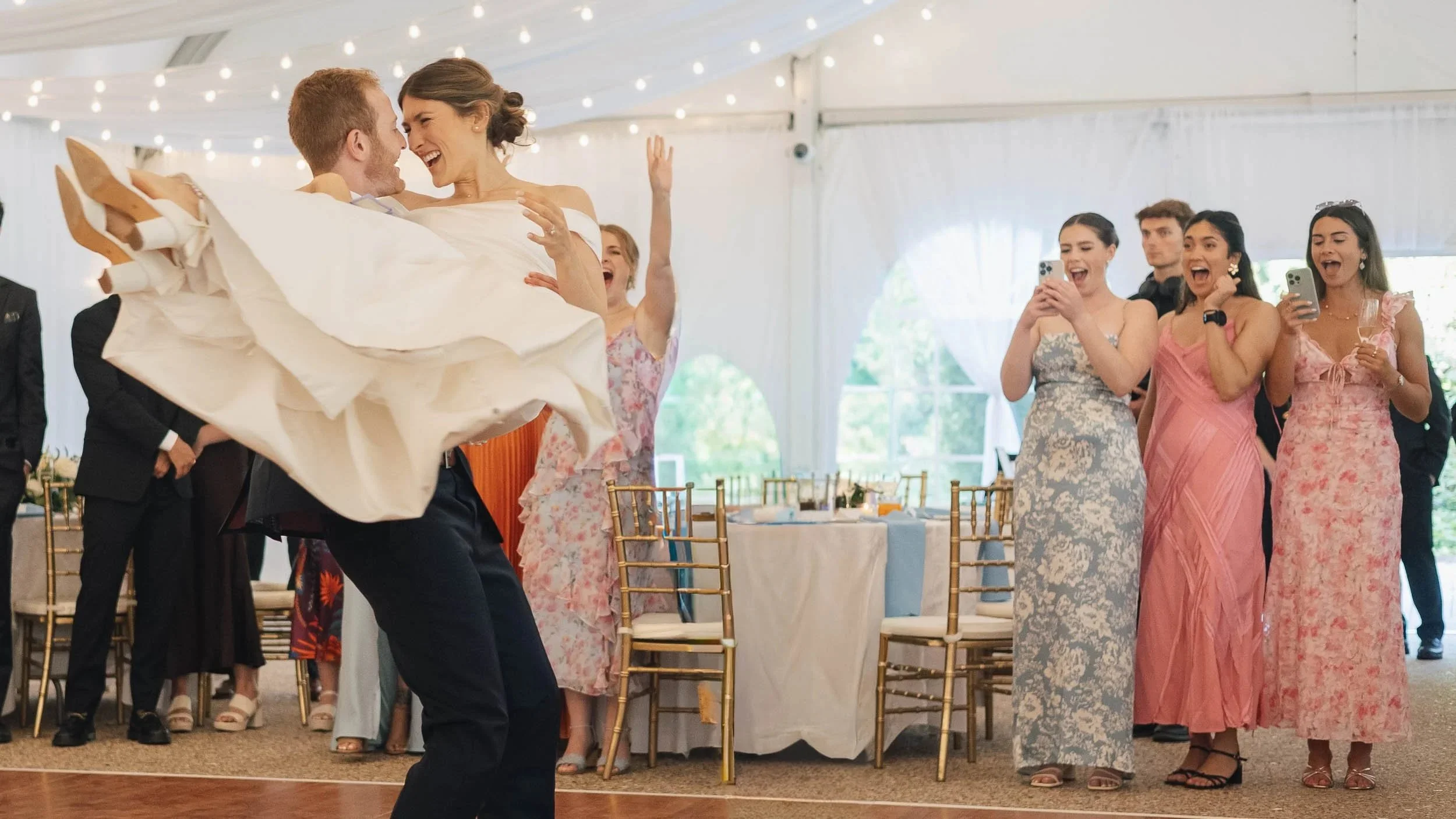 groom picking up the bride during their first dance during the sarasota wedding reception.
