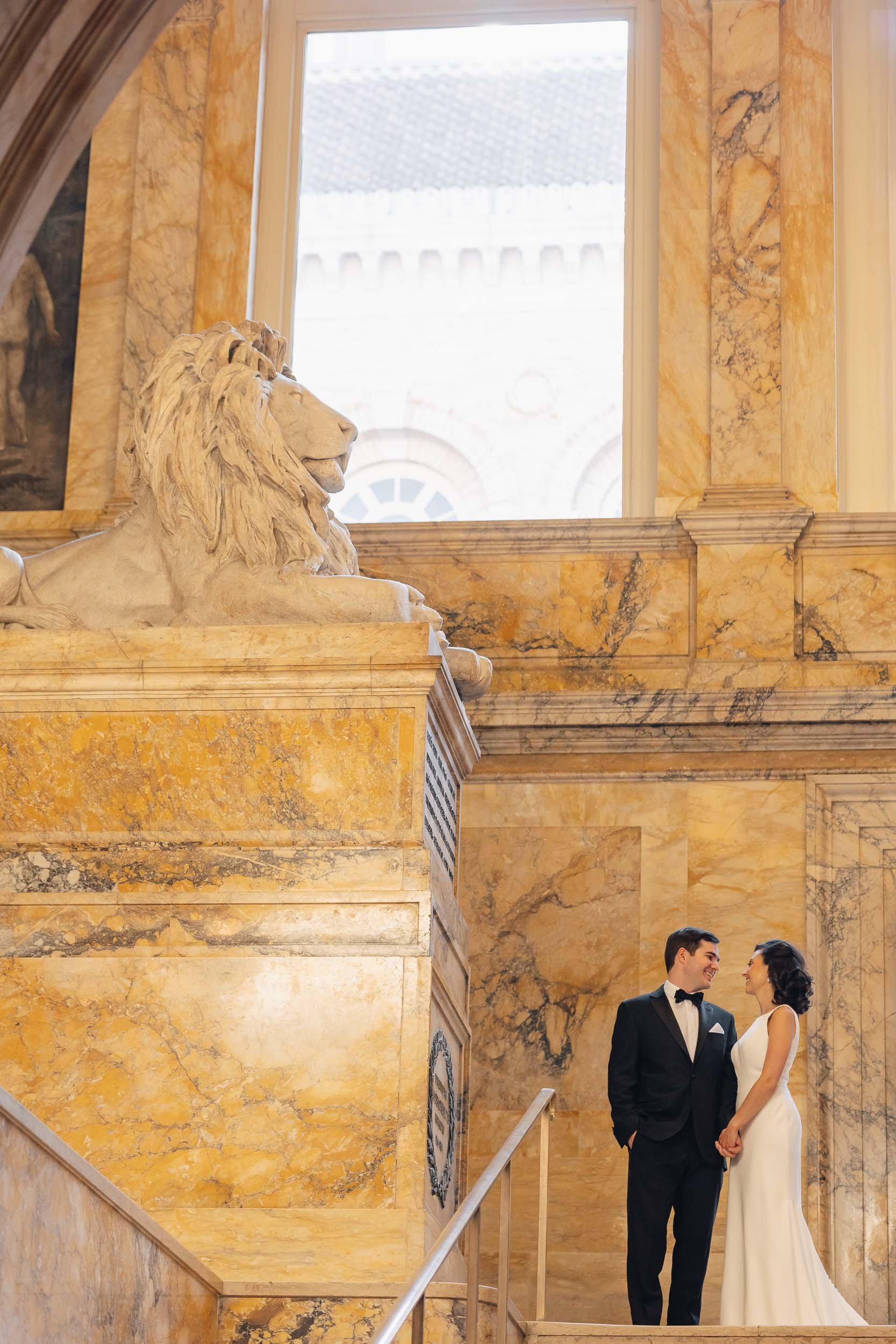 Couple sharing a quiet moment on the library’s marble staircase.