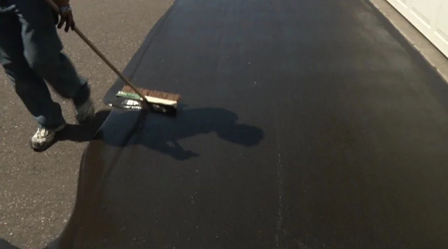 Bryer and Sons crew applying sealcoat to asphalt