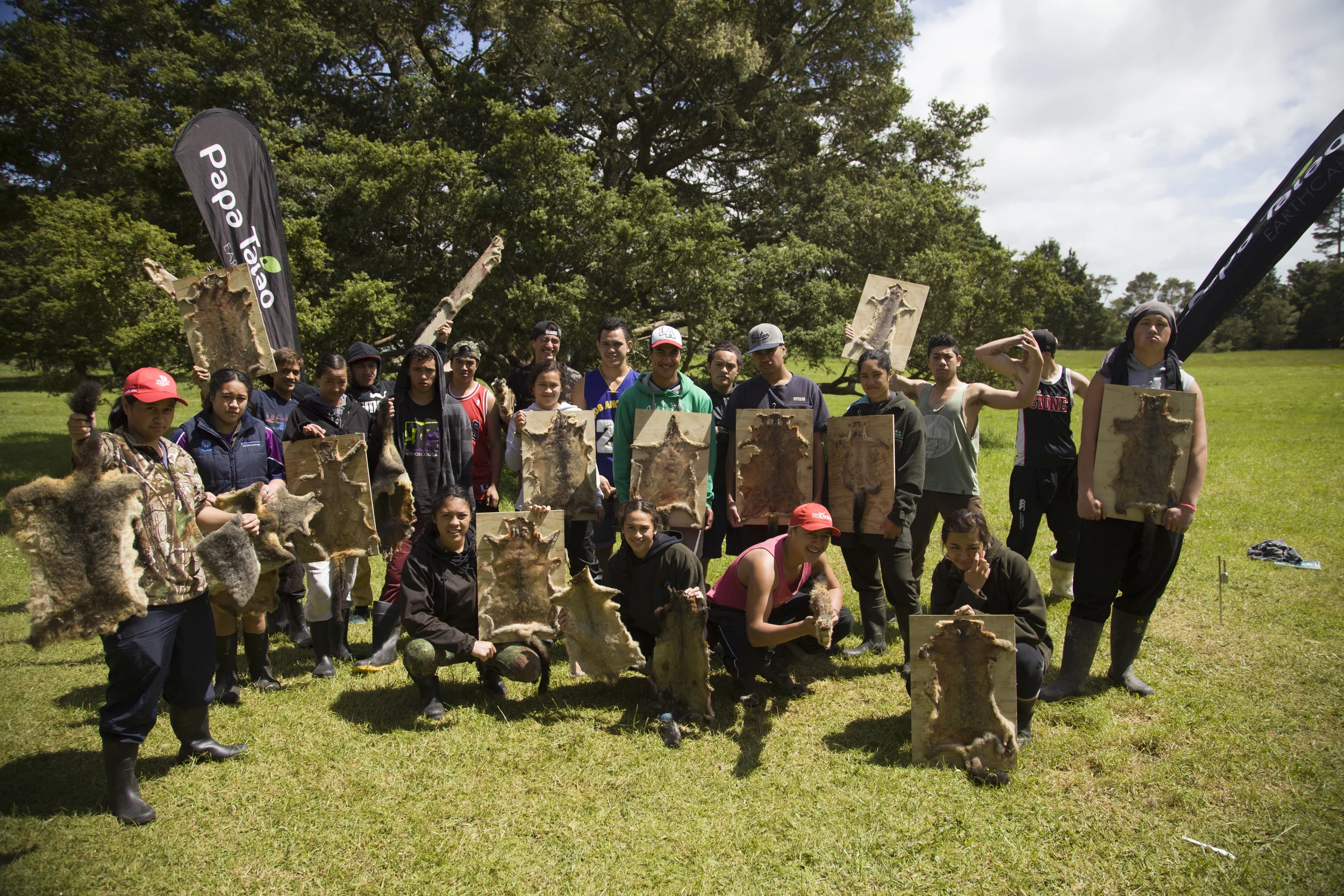 Te Kura kaupapa Maori o Kaikohe students holding up their possum furs. All Papa Taiao Earthcare courses encourage enterprise. Students leave with 5 traps and a small business when they complete the Project Possum course.