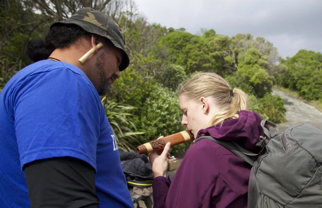 Horomona Horo teaching students how to make music from traditional Taonga Pūoro (Māori instruments).