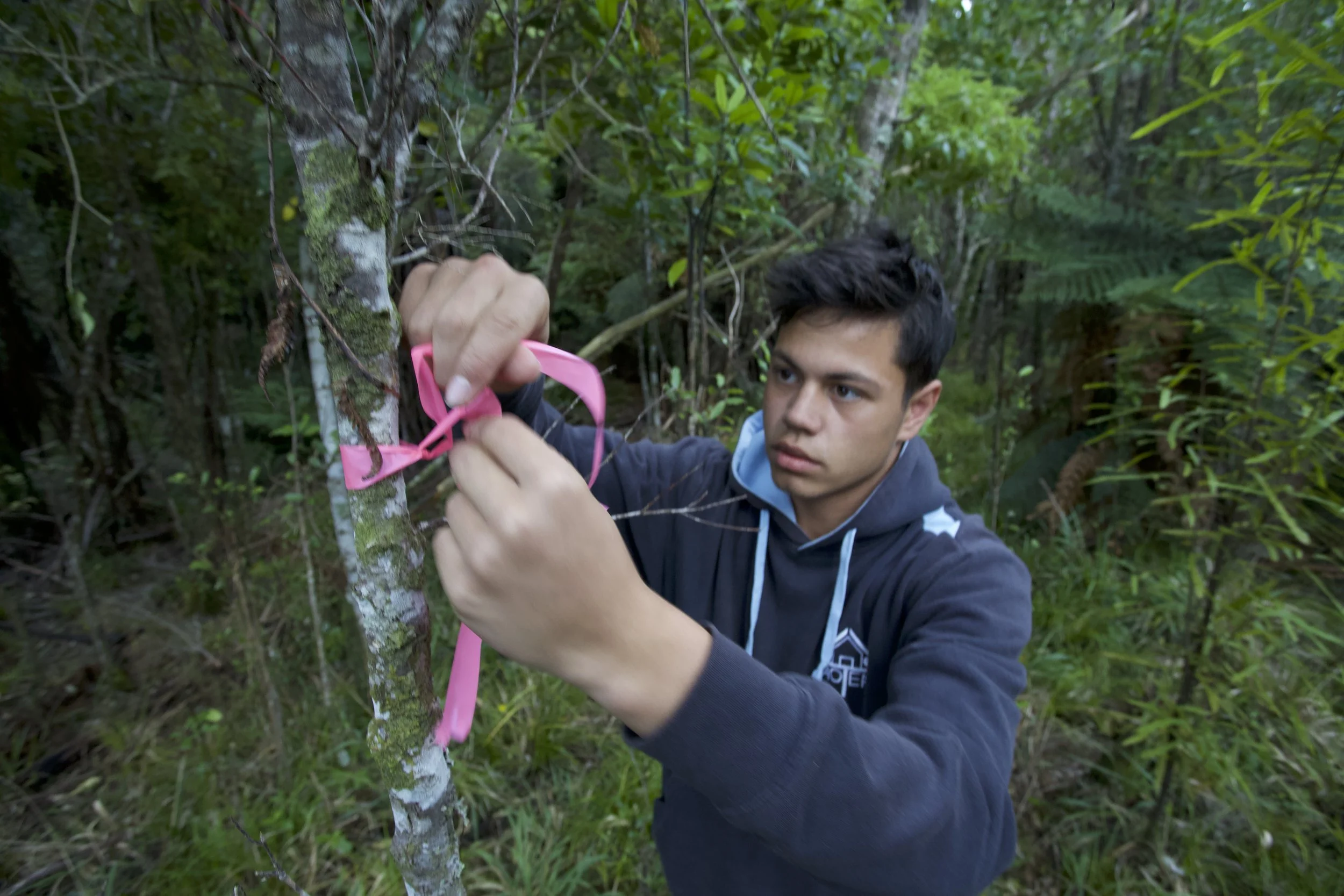 Aotea College students marking where he places his traps in the RImutakas.