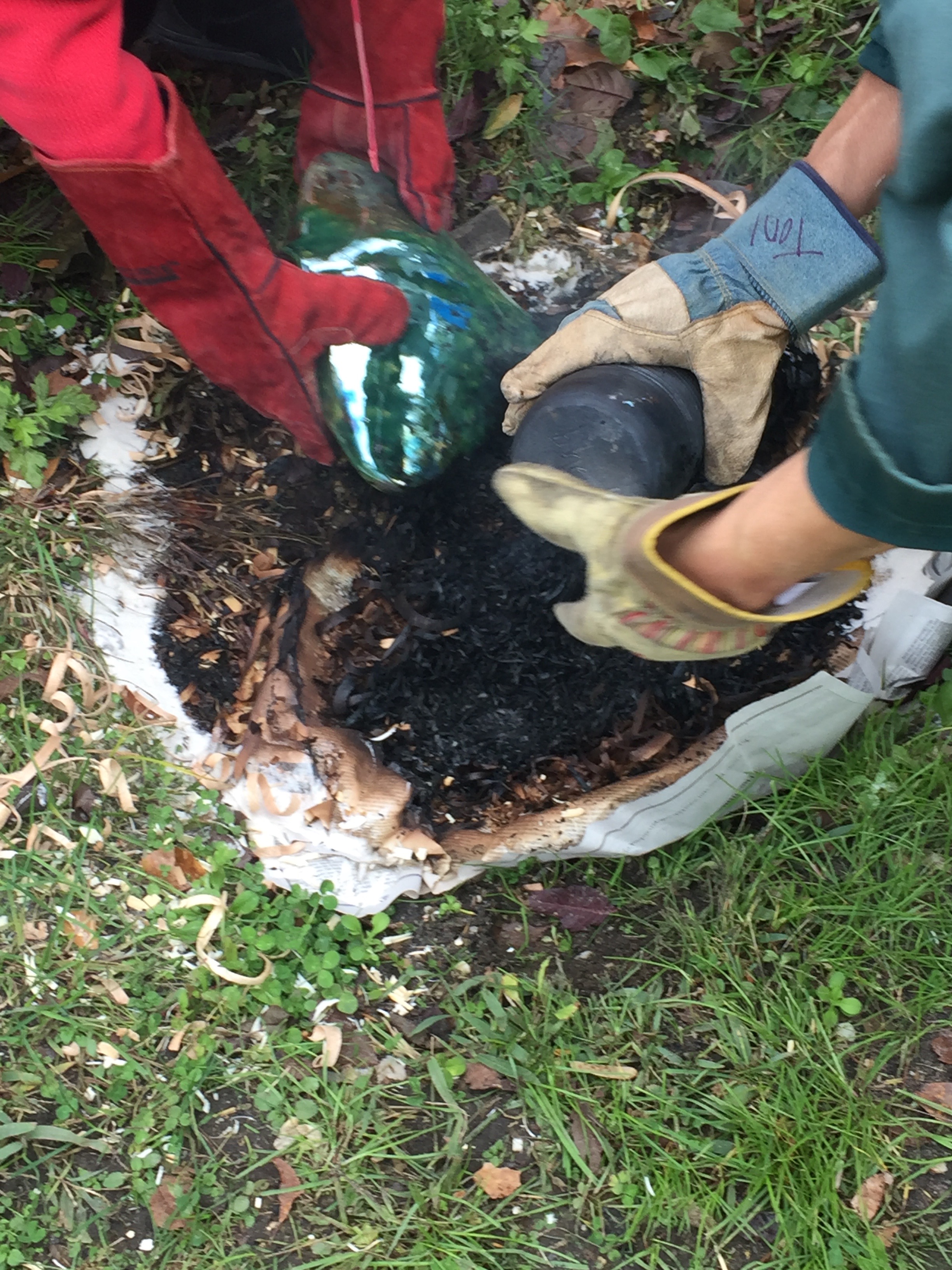 Removing the pots from the pit