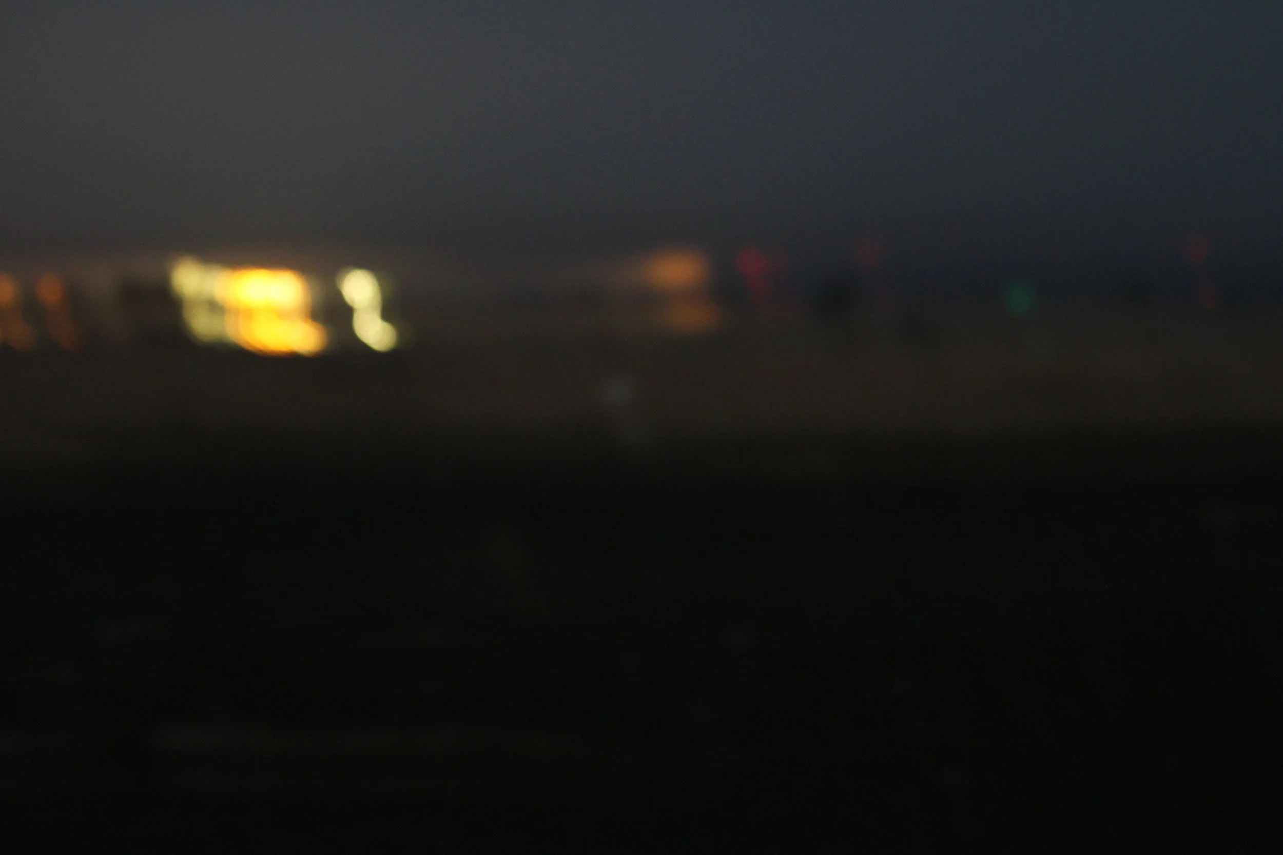 Notice the white blob in the center? It's a giant piece of nautical-related styrofoam. But at the time, I wondered if it was a snowy. Took this image with a telephoto, at 3am. Hence, it is just a bunch of stray colors. 