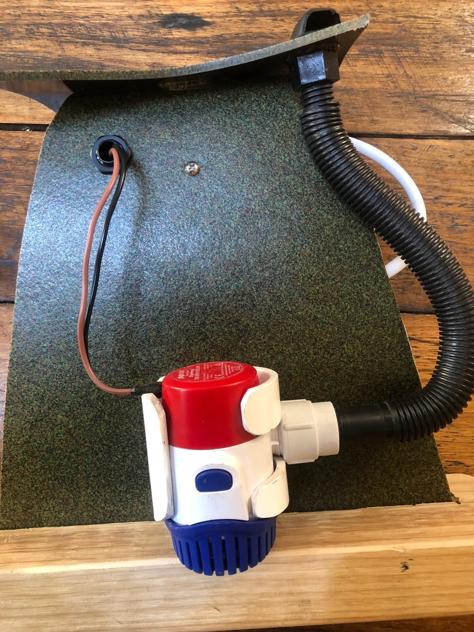 Rule Pump Kit - pump, bracket hose and outlet - view from inside the 'cockpit' behind the seat