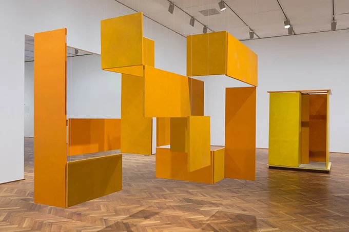 Exhibit and installation design by Space Haus for Helio Oiticica at AIC in Chicago, Illinois. Hanging orange, yellow abstract art panels.