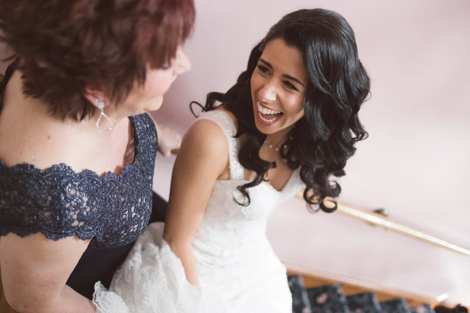 Top of 17 | Number 9 | Brooke & Anthony | Getting Ready Fuji XT2 | Fuji 23 f1.4 It was my third wedding of the season. I leaned over the railing to get a photo of Brooke walking down the stairs and happened to catch this perfectly candid photo of her looking back at her mom. I love this photo, and I knew, even back in March that it would end up on this list. 200,000 photos later and here we are. 