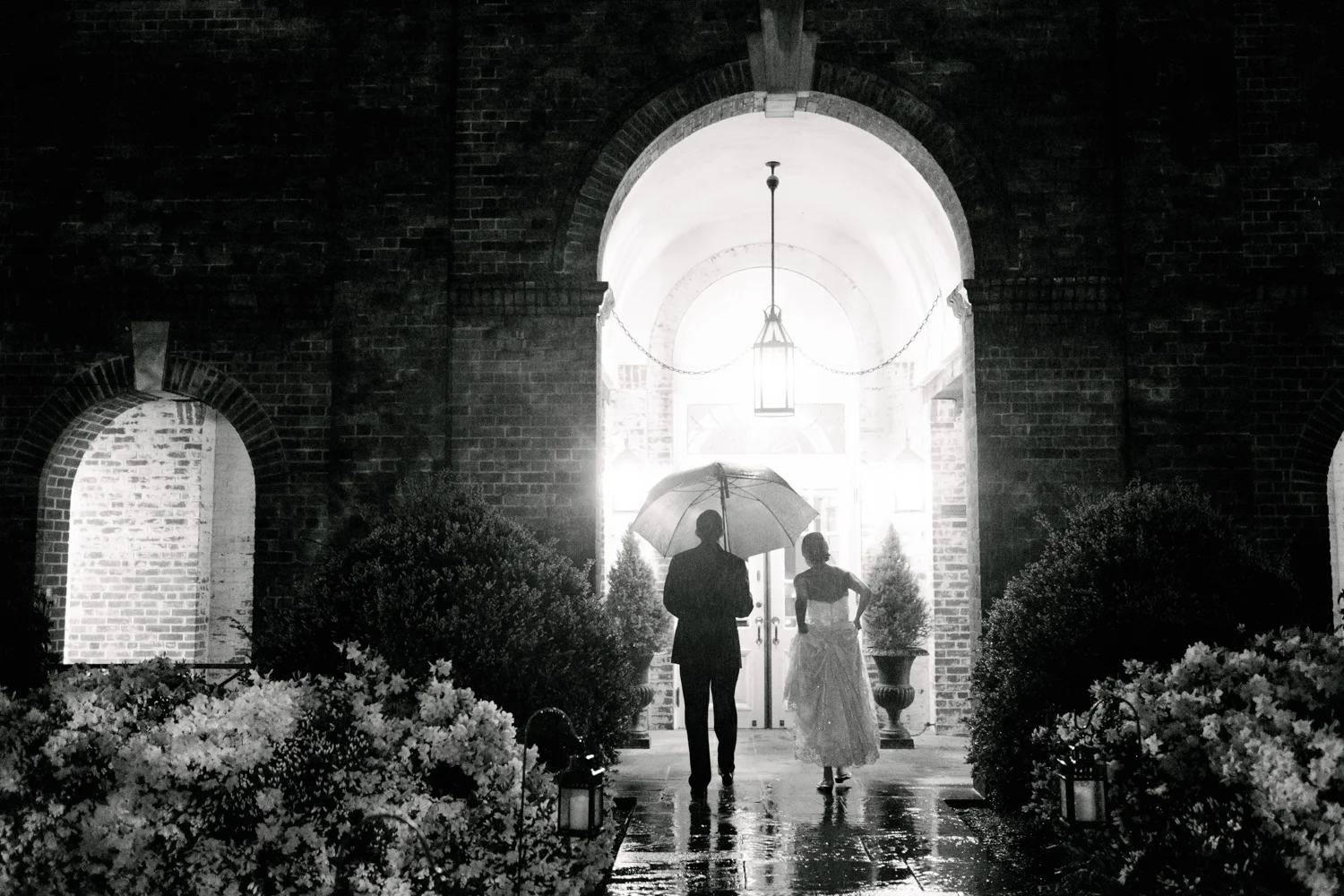 Top of 17 | Number 5 | Jessica & Colin | The New Haven Lawn Club (in the rain!) Fuji XT2 | Fuji 23 f2 It rained on Jessica and Colin's wedding day... hard. It really didn't stop. Nor did it stop them from having one of the more memorable weddings of my season. Rain is what you make it. It poured on mine and Corey's wedding day, but we had a blast. In this photo, after we had finished some rainy evening portraits, I stayed back as the couple made their way inside. The photos we took were cool, but this quick and candid moment is the clear winner. I love the mood, the drama, the soaking wet pathway, the unlit candles, the way she's hiking her dress...it's everything a photo in the rain should be. If Jessica and Colin werent so willing to come stand in a downpour with me, it never would have happened. I'm so glad they did.
