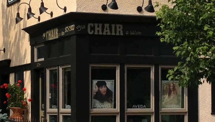 Storefront of the salon with window displays