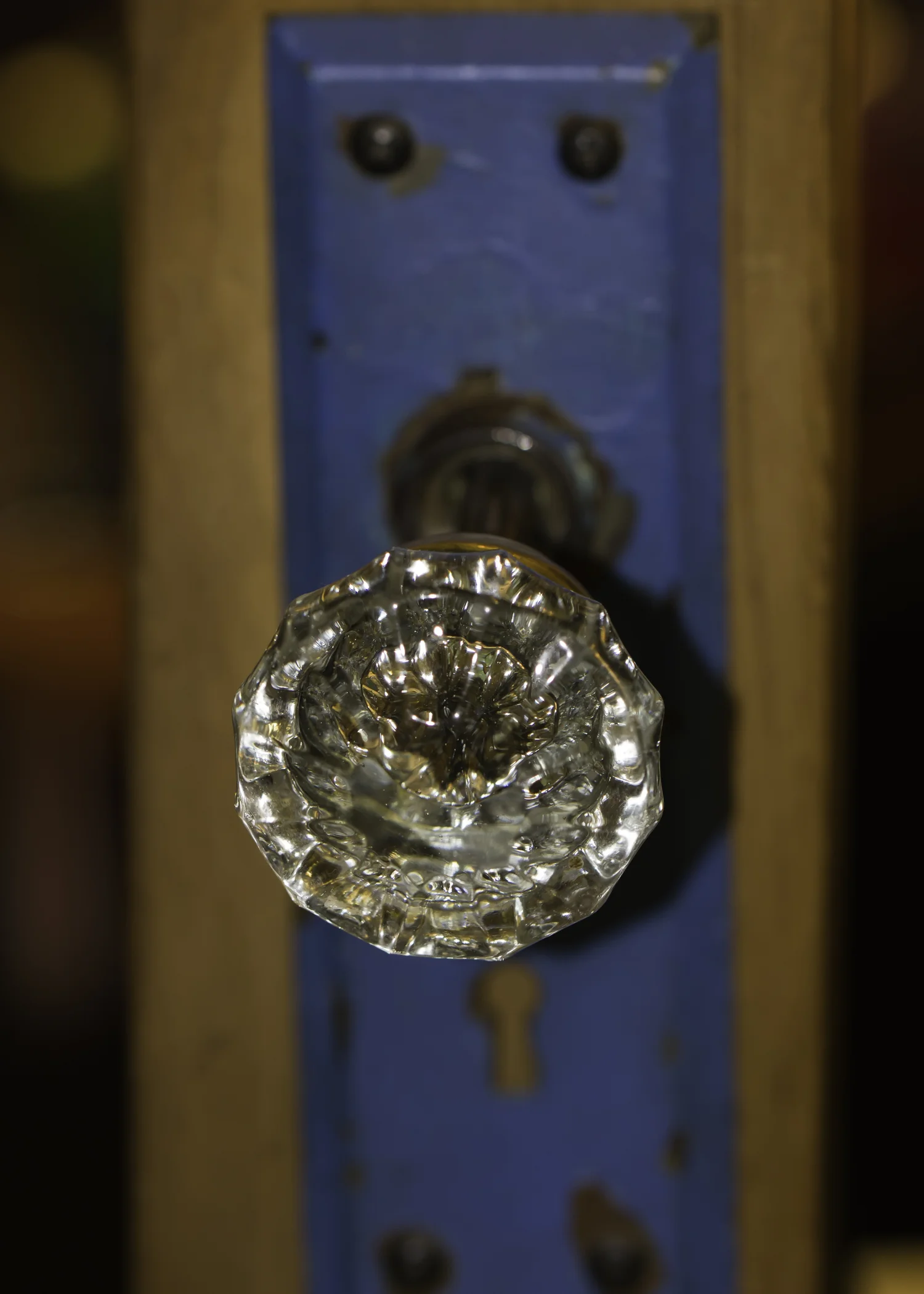 Vintage glass door knob on a blue door