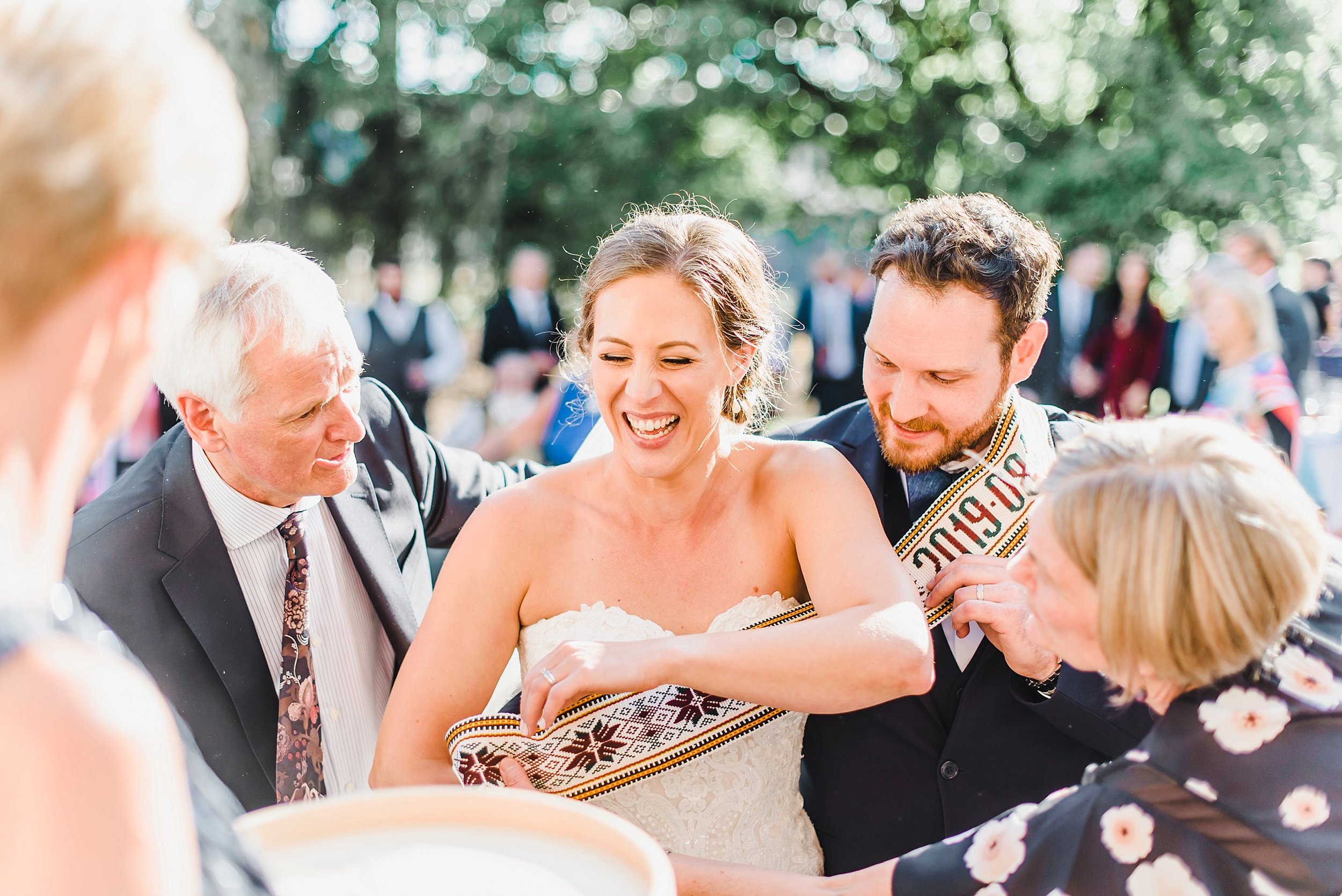  Then came back to celebrate the beginning of the festive night with some Lithuanian traditions! A huge entrance full of dancing and kisses and offering the bride and groom cake upon entering the reception space. 