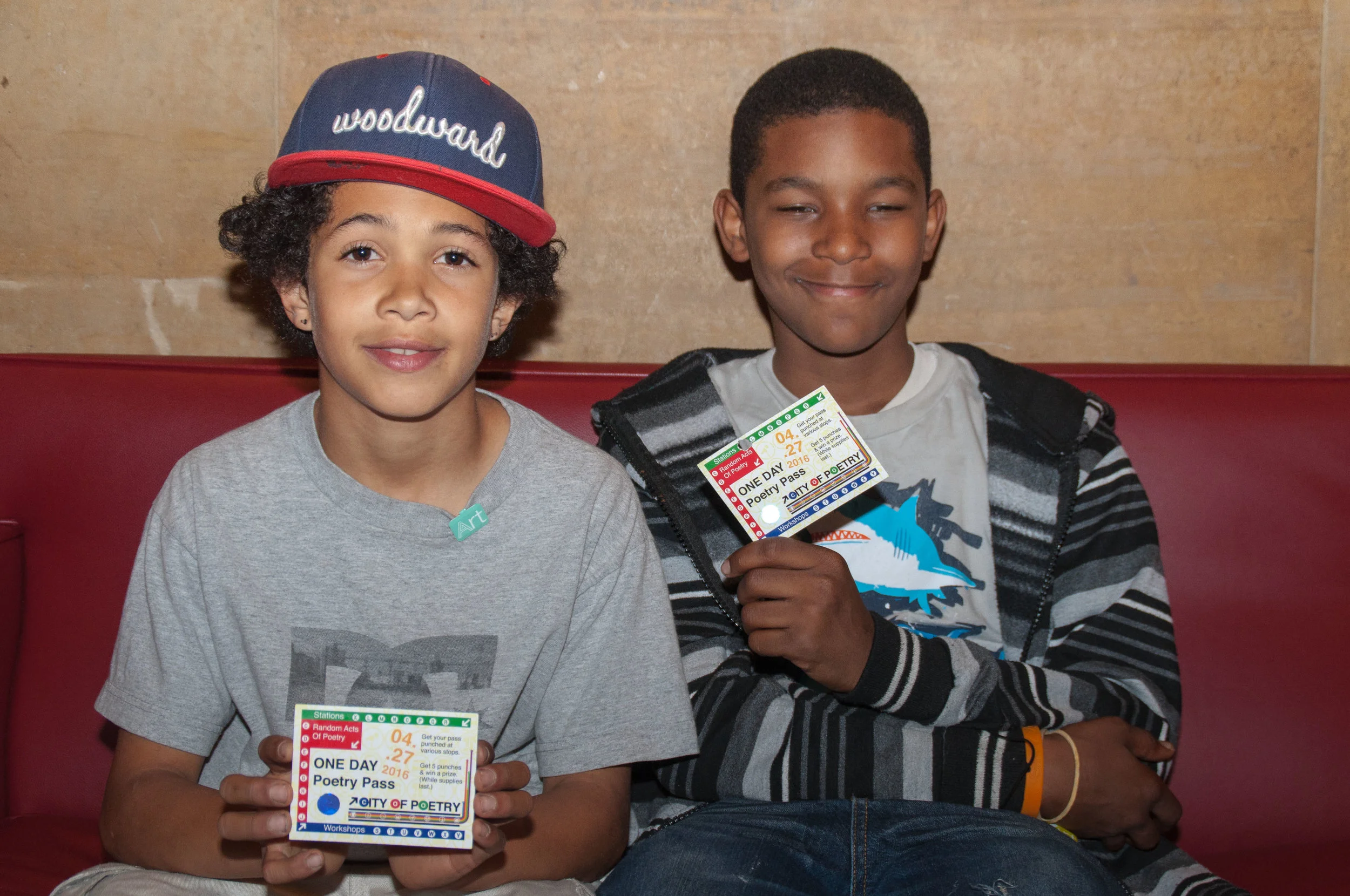 Two students from The Jubilee School in West Philadelphia hold City of Poetry passes. Visitors got their passes punched at poetry stations to earn a prize. Photo by Tieshka Smith.