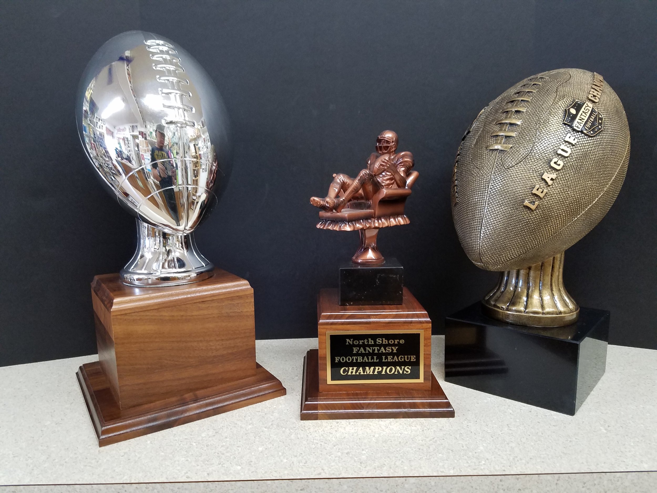 SILVER FOOTBALL (15") - 182.00, FANTASY FOOTBALL TROPHY (12") - 126.00, FANTASY LEAGUE CHAMPION BALL (13") - 149.00